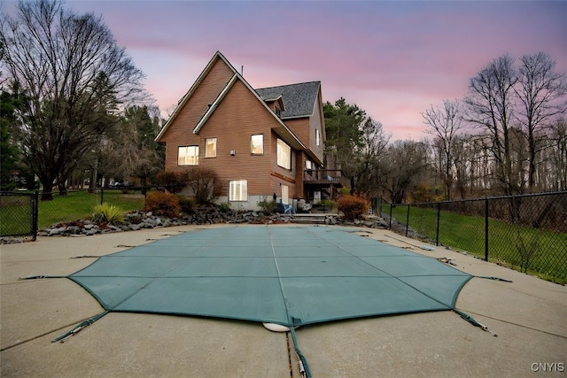 view of pool at dusk