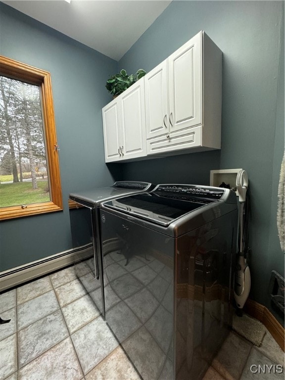 washroom featuring washing machine and clothes dryer and cabinets