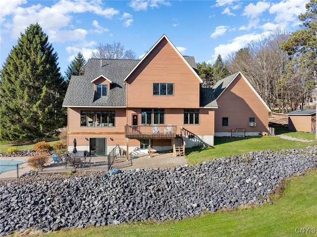 rear view of house featuring a yard, a patio, and a wooden deck