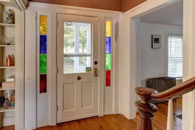 doorway to outside featuring a healthy amount of sunlight and light hardwood / wood-style floors