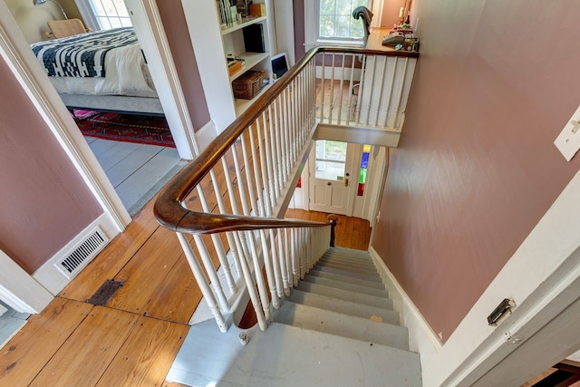 staircase featuring wood-type flooring