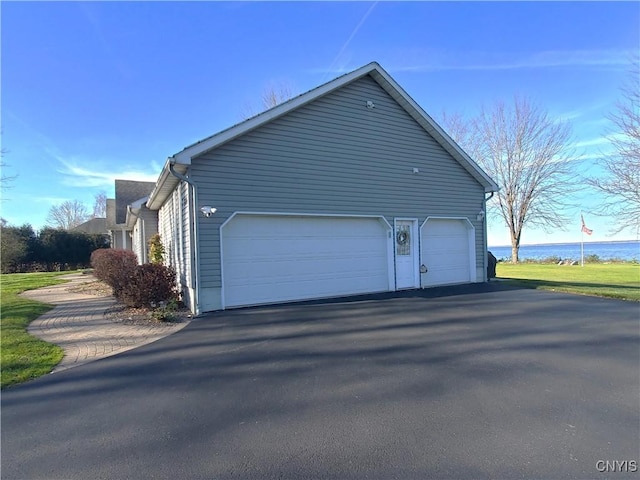 view of home's exterior with a water view and a garage