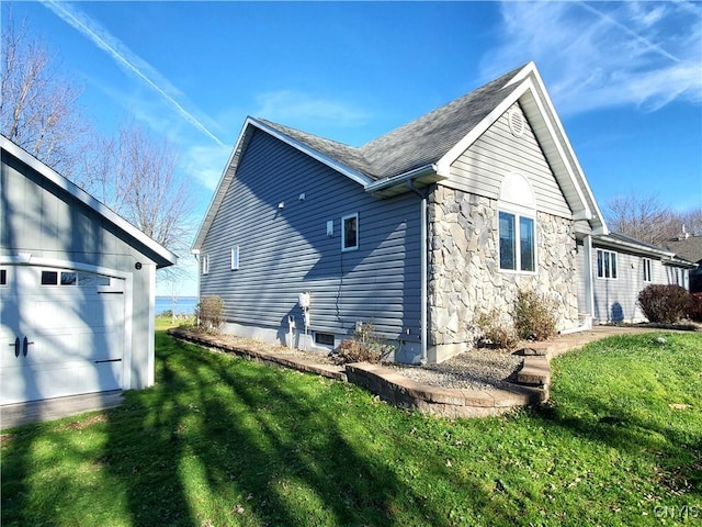 back of house with a yard and a garage