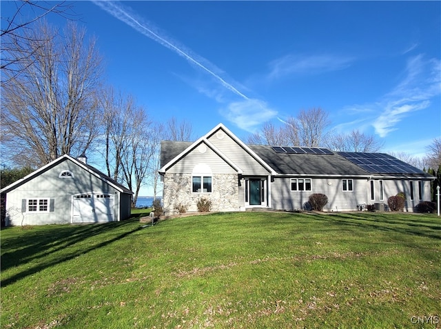 rear view of property featuring solar panels, a garage, and a yard