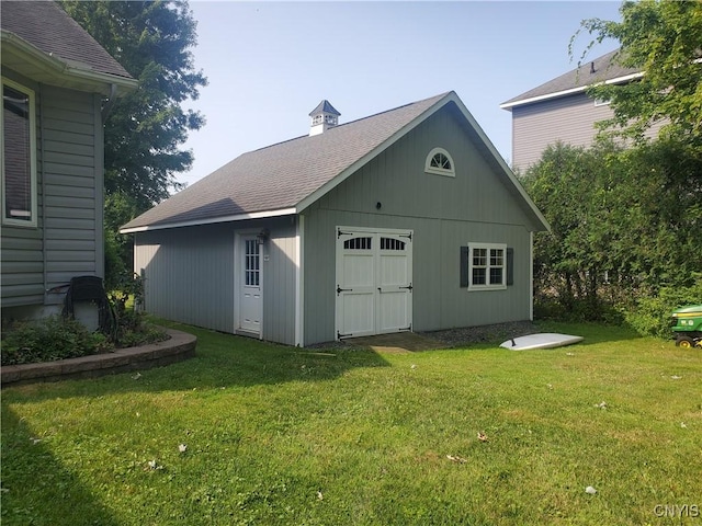 view of outbuilding with a lawn