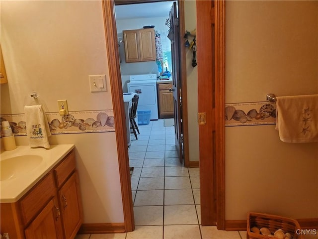 bathroom featuring washer / dryer, vanity, and tile patterned floors