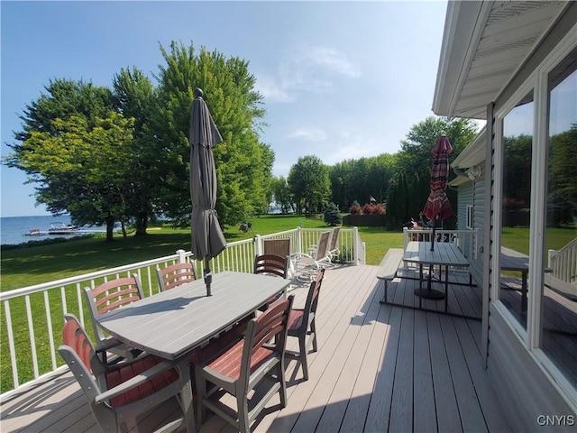 deck with a lawn and a water view