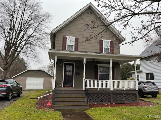 front of property with a front yard, covered porch, an outdoor structure, and a garage