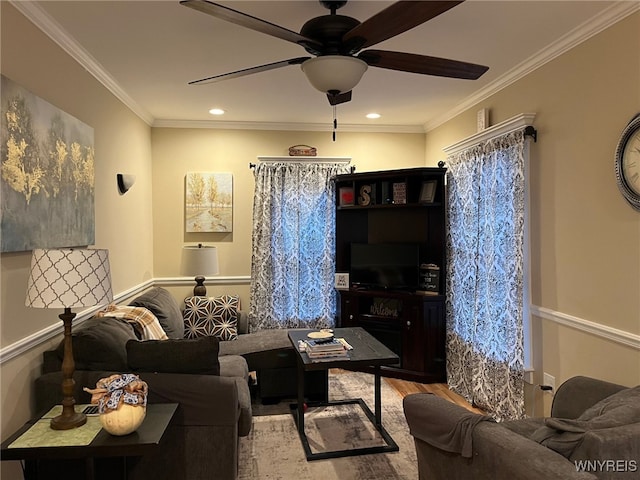 living room featuring hardwood / wood-style floors, ceiling fan, and crown molding