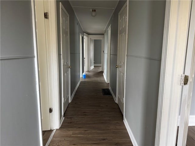 hall with dark hardwood / wood-style floors