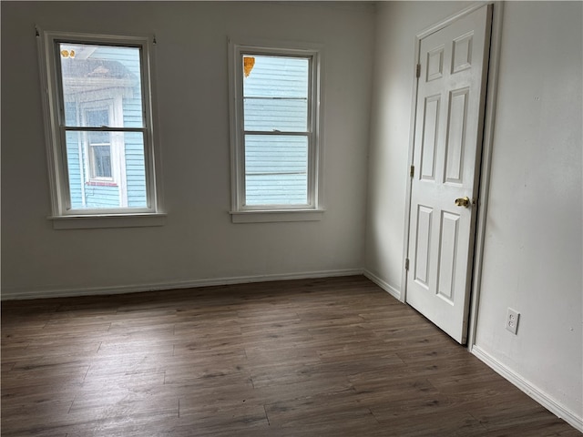 empty room featuring dark hardwood / wood-style flooring