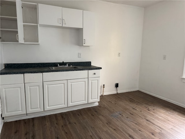 kitchen featuring sink, white cabinets, and dark wood-type flooring