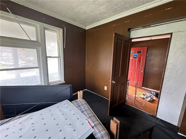 bedroom featuring ornamental molding and a textured ceiling