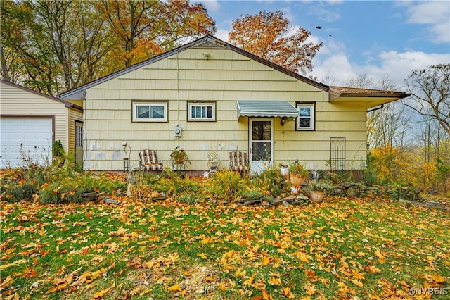 back of property featuring a garage