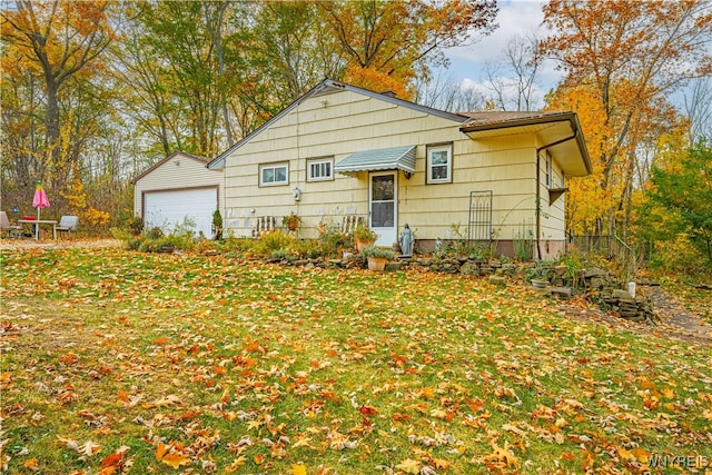 exterior space featuring a garage and a front lawn