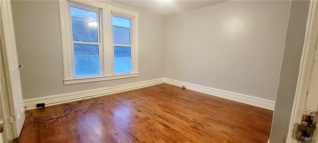 empty room with hardwood / wood-style floors