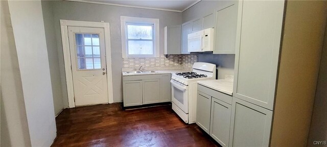 kitchen featuring white cabinetry, dark wood-type flooring, tasteful backsplash, white appliances, and ornamental molding