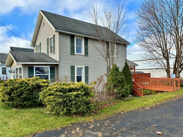 view of side of property with a wooden deck