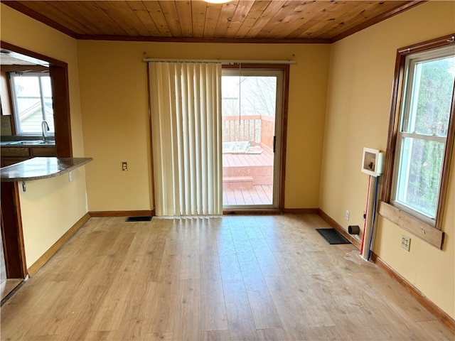 unfurnished dining area with wooden ceiling, light hardwood / wood-style flooring, and a healthy amount of sunlight