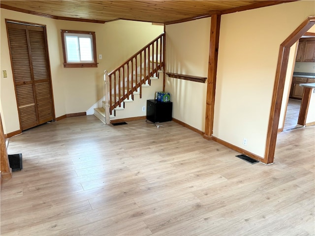 interior space featuring light hardwood / wood-style floors, crown molding, and wood ceiling