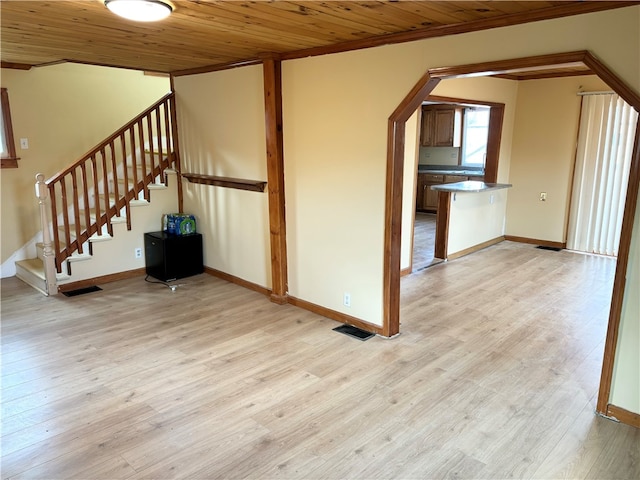 interior space with crown molding, light hardwood / wood-style flooring, and wood ceiling