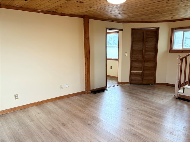 interior space featuring light wood-type flooring, wood ceiling, and crown molding