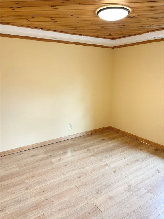 spare room with light hardwood / wood-style floors, wood ceiling, and ornamental molding