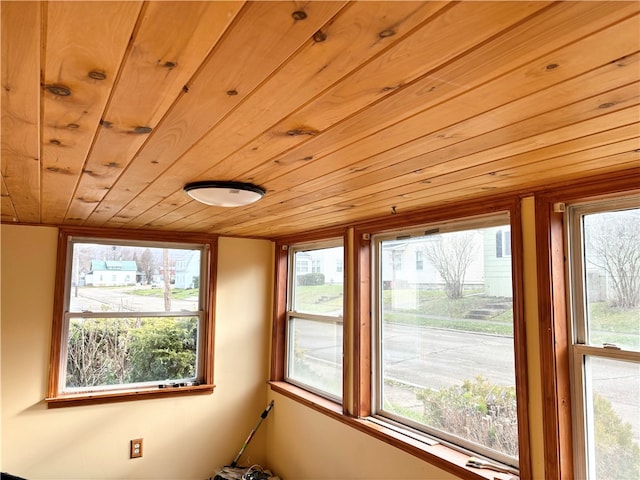 unfurnished sunroom with wooden ceiling