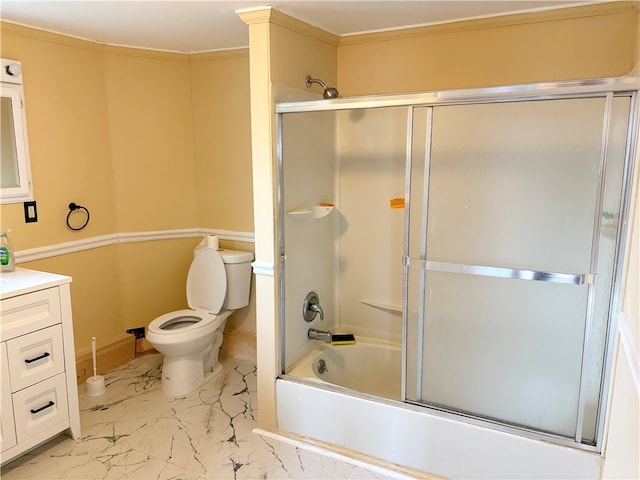 full bathroom featuring toilet, vanity, ornamental molding, and combined bath / shower with glass door