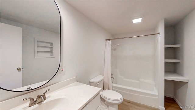 full bathroom with shower / tub combo, vanity, toilet, and hardwood / wood-style floors