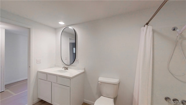 bathroom featuring a shower with curtain, toilet, and vanity