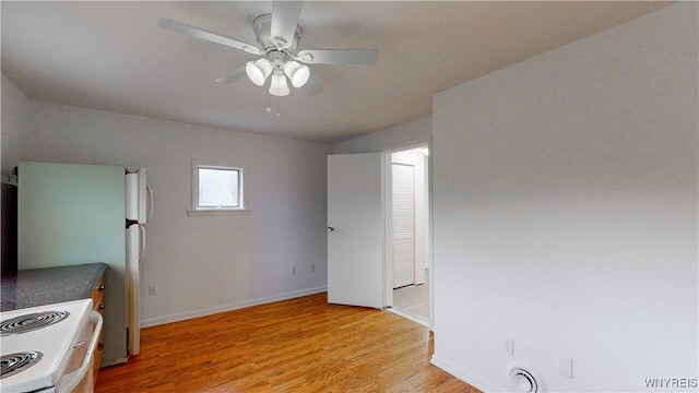 kitchen featuring light hardwood / wood-style floors, white range with electric stovetop, and ceiling fan