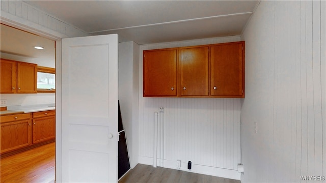 kitchen featuring light hardwood / wood-style floors and wood walls