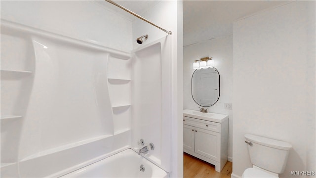 full bathroom featuring hardwood / wood-style floors, vanity, toilet, and bathing tub / shower combination