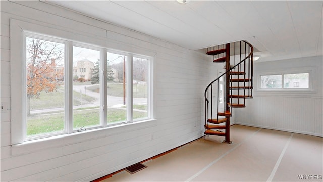 interior space featuring a wealth of natural light and wood walls