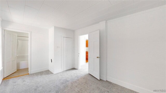 unfurnished bedroom featuring light carpet