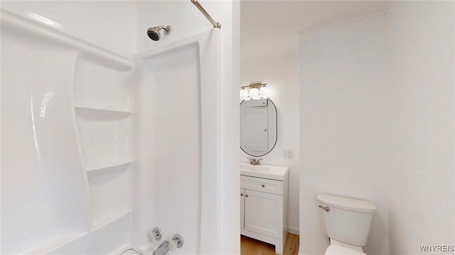 bathroom with toilet,  shower combination, and vanity