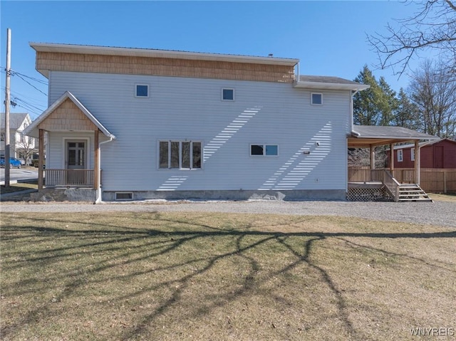 back of house with a lawn and a porch