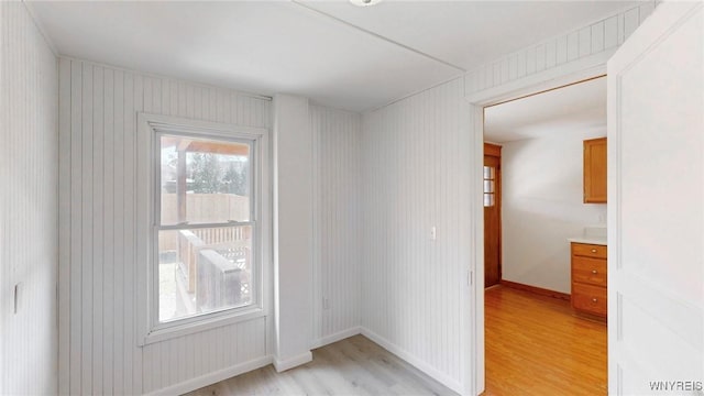 unfurnished room featuring light wood-type flooring and baseboards