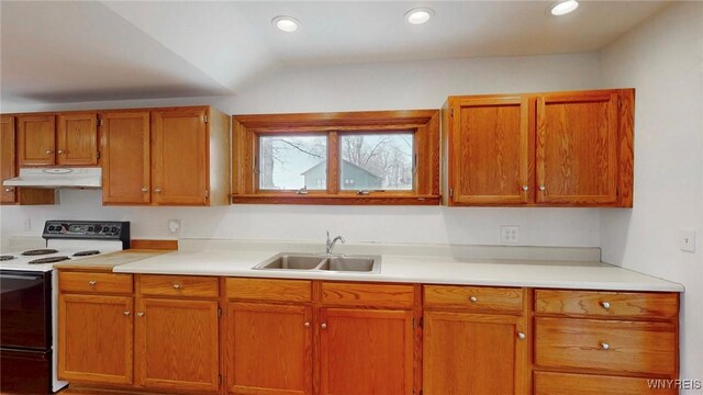 kitchen with under cabinet range hood, electric range, light countertops, and a sink