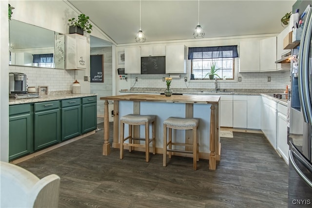 kitchen with dark wood-type flooring, white cabinets, pendant lighting, and green cabinetry