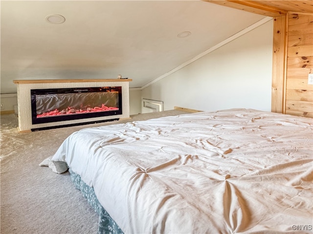 bedroom with carpet, ornamental molding, and lofted ceiling