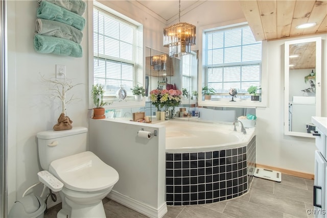 bathroom featuring a chandelier, toilet, plenty of natural light, and a tub