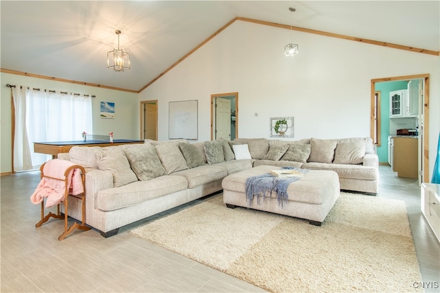 living room with hardwood / wood-style floors, high vaulted ceiling, and a chandelier