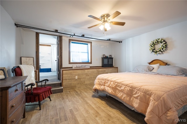 bedroom featuring light hardwood / wood-style flooring and ceiling fan