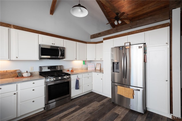 kitchen with appliances with stainless steel finishes, vaulted ceiling with beams, and white cabinetry