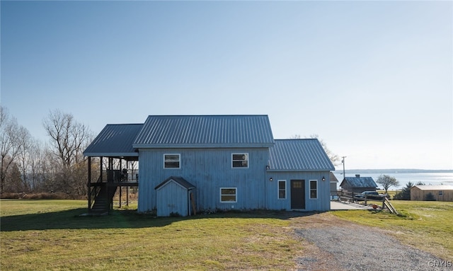 rear view of property featuring a yard