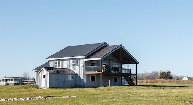 rear view of house featuring a deck and a yard