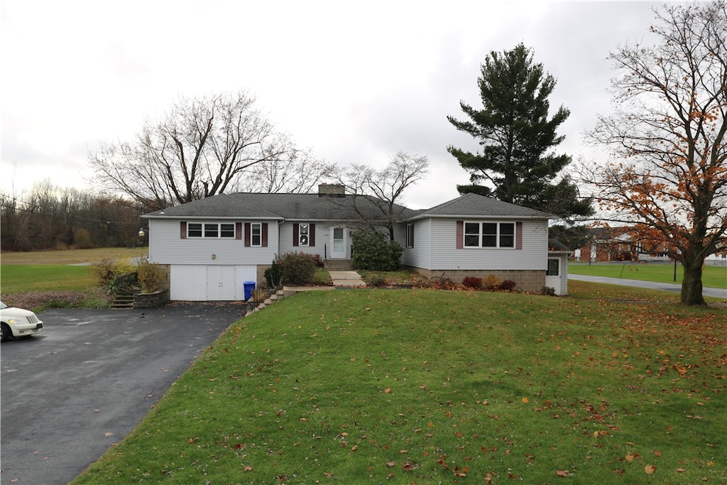 view of front of house with a front yard and a garage