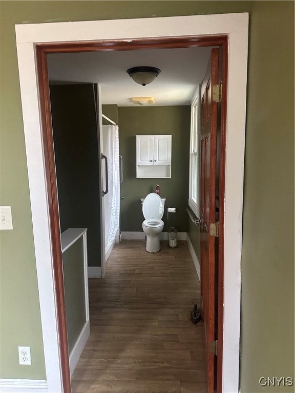 bathroom with hardwood / wood-style floors and toilet